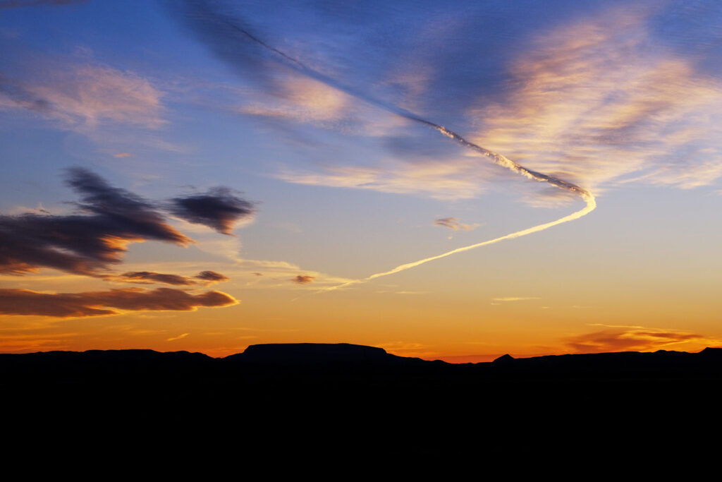 A desert circled by wind and mountains