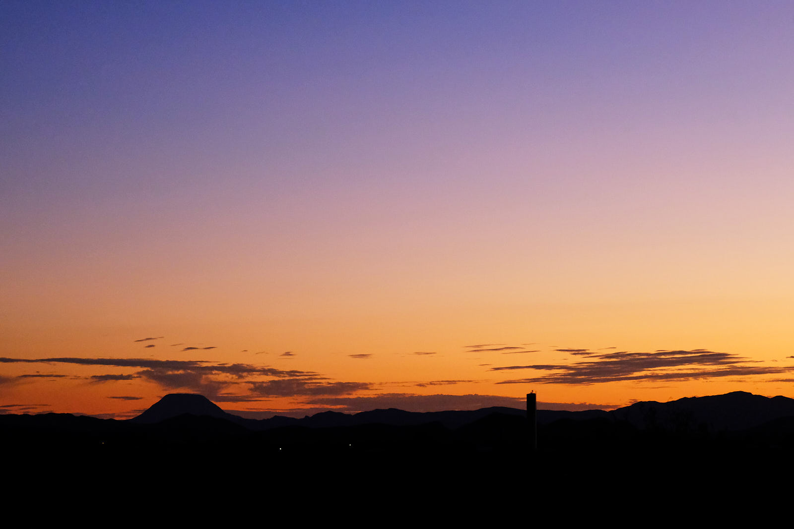 The sky puts on the darkening blue coat